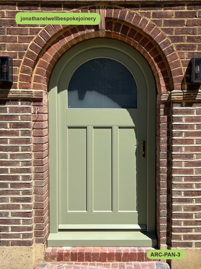 arched panelled door and frame lichen
